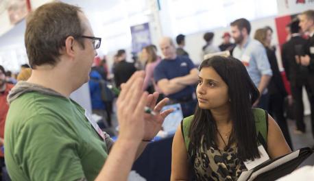 A student talks with an employer during one of WPI's biannual career fairs held in the Sports & Recreation Center.