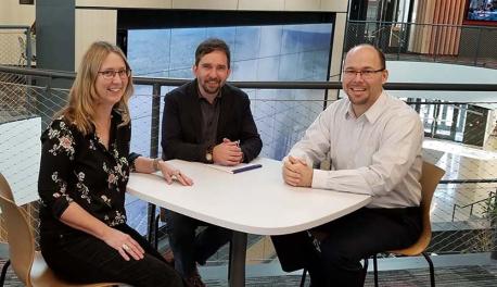 Ingrid Shockey, Stephen McCauley, and Andrew Trapp sit at a table together in the Foisie Innovation Studio.