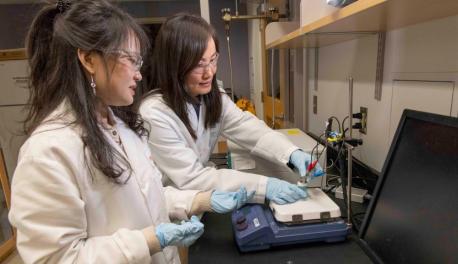 Chemical engineering professor Hong Susan Zhou, right, and PhD candidate Zhiru Zhou prepare a prototype of an electrochemical sensor that can quickly detect the presence of C. diff bacteria, which causes a potentially deadly gastrointestinal infection.