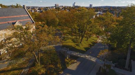 An aerial photo of Boynton Hall and Earle Bridge with trees and fall foliage in the background.