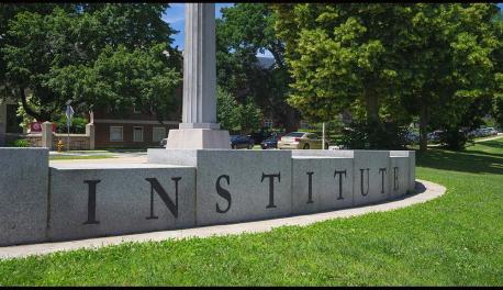 A close-up photo of "INSTITUTE" written in stone at Institute Park.