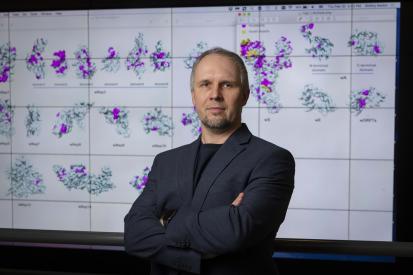 WPI bioinformatics researcher Dmitry Korkin with 3D models of the novel coronavirus.