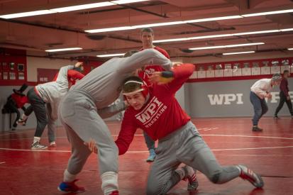 WPI wrestler Tyler Marsh practices a move under the watchful eye of Coach Matt Oney.