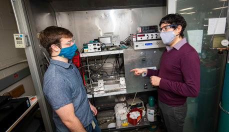 WPI professor Andrew Teixeira (right) confers with PhD student Cameron Armstrong, who custom built an ultrafast micro catalytic reactor to produce ammonia.
