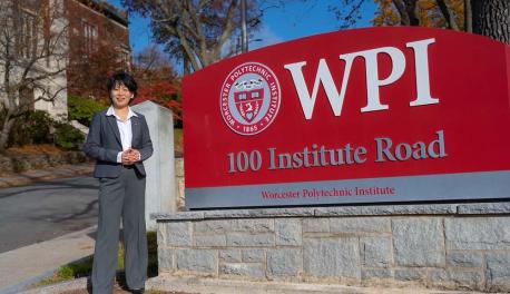 Grace Wang standing in front of the WPI sign