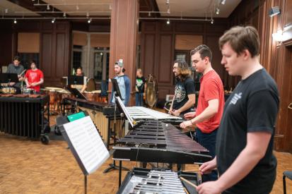 Students rehearse on keyboard, xylophone, and other instruments in Alden Memorial.