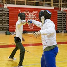 2 students fencing with swords