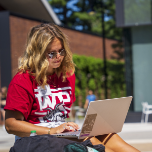 WPI Student studying outside in the sun