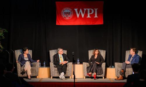 WPI President Grace Wang and three expert panelists sit on stage while discussing A.I. and the future of work