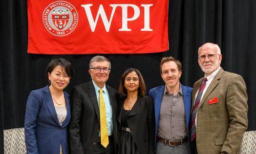 WPI President Grace Wang, Interim Provost Art Heinricher, and three experts on A.I. posing together before the University Lecture Series panel event, "A.I. and the Future of Work"