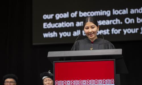 Jezabel Aleyda Aponte Figueroa stands at the podium while giving a speech to welcome President Wang to WPI 