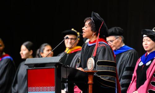 Rev. Debora Jackson stands at the podium while delivering the invocation at President Grace Wang's inauguration.