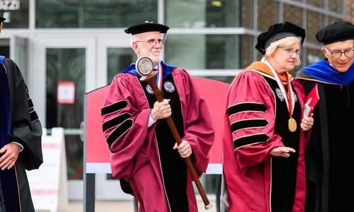 Faculty marshal holds the WPI mace during the inauguration recessional