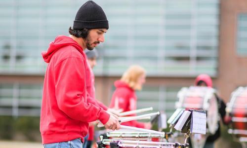 Members of the WPI Marching and Pep Band play music on the quad while the inauguration recessional passes by