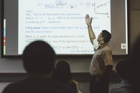 Math professor teaching statistics on projector