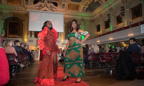WPI students, from left,  BSU president Mbolle Akume '20, and BSU vice president Rejoice Attor '21, at the end of the runway during the fashion show. alt