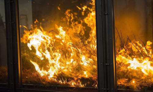 An experimental fire burns in a wind tunnel at WPI alt