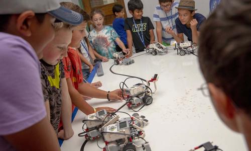 Students observe a robot in action.