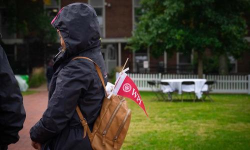 A WPI pennant sticks out of a backpack.