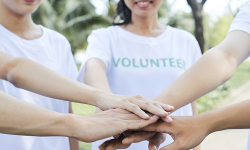 Volunteers join hands together
